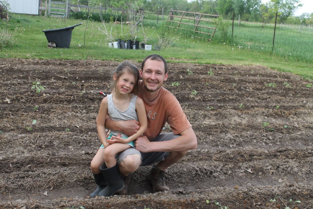 father and daughter planting garden