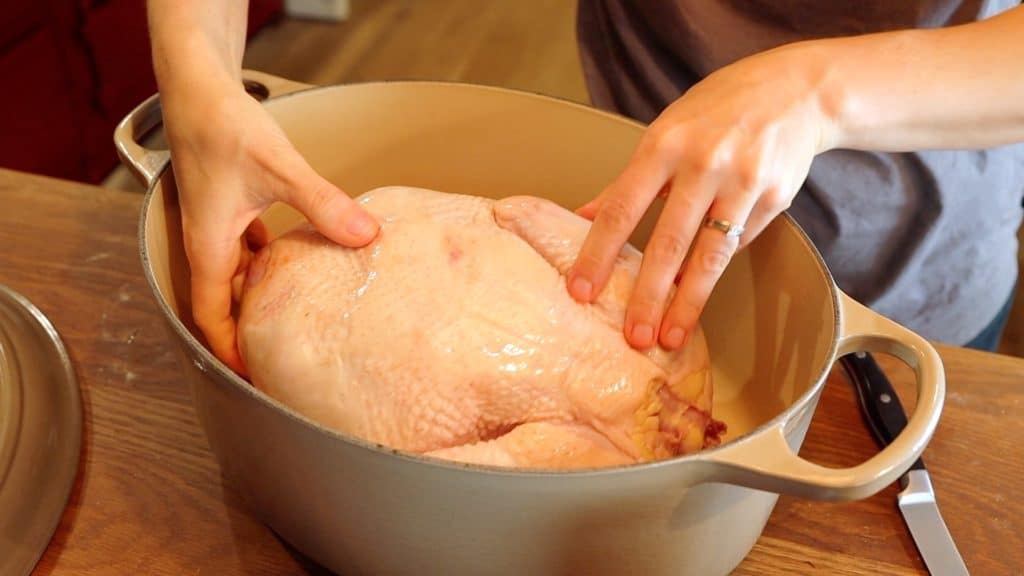 placing whole chicken in dutch oven