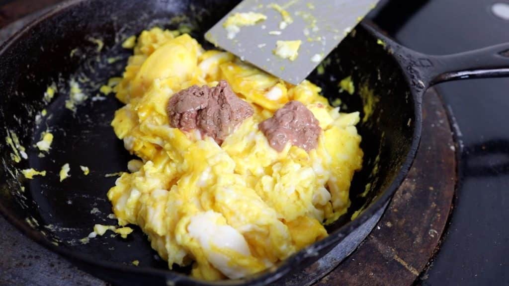 mixing chicken liver and heart paste into eggs