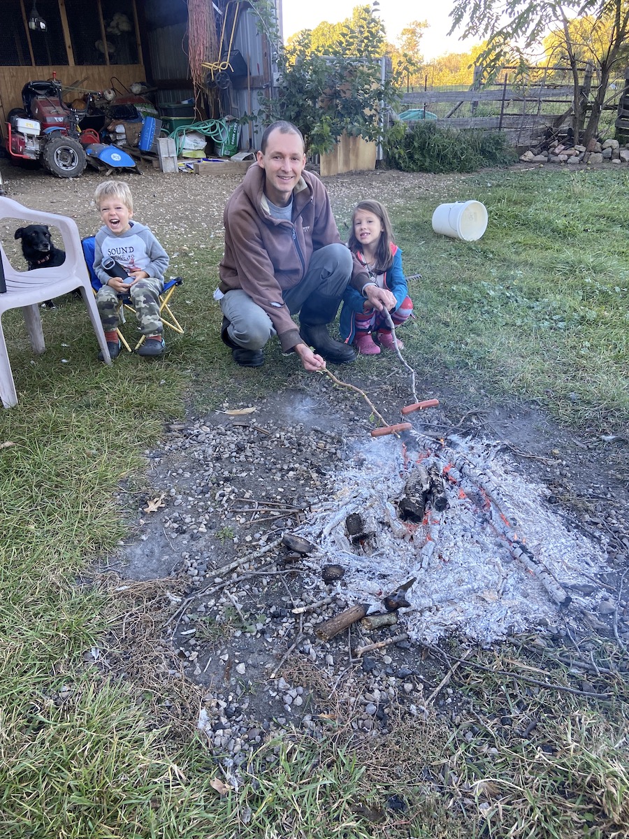roasting hotdogs while backyard camping