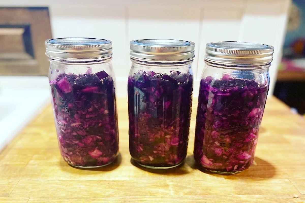 jars of homemade sauerkraut fermenting on counter