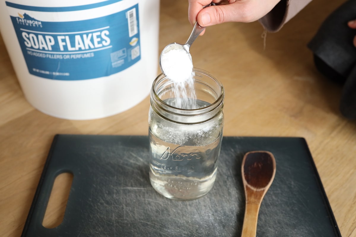 adding soap flakes to boiling water to make soap finish