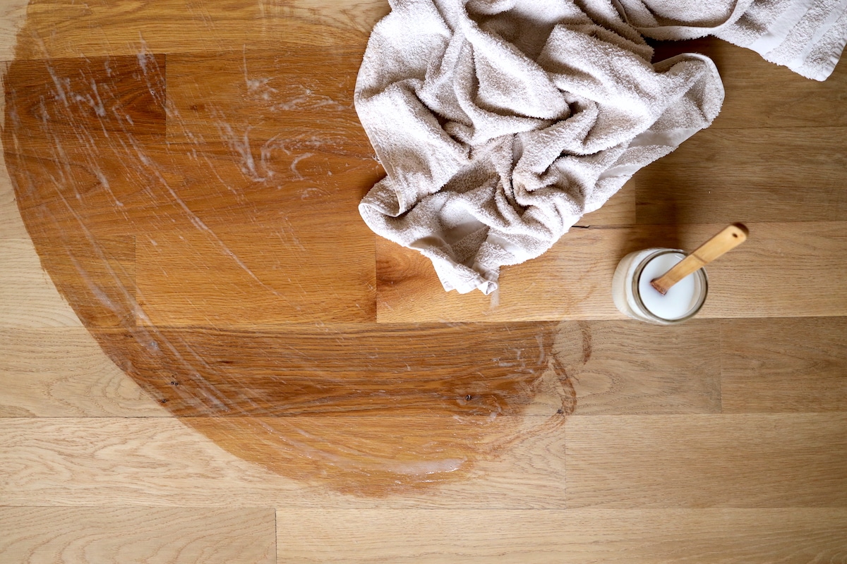 applying wood soap finish with bath towel on floors