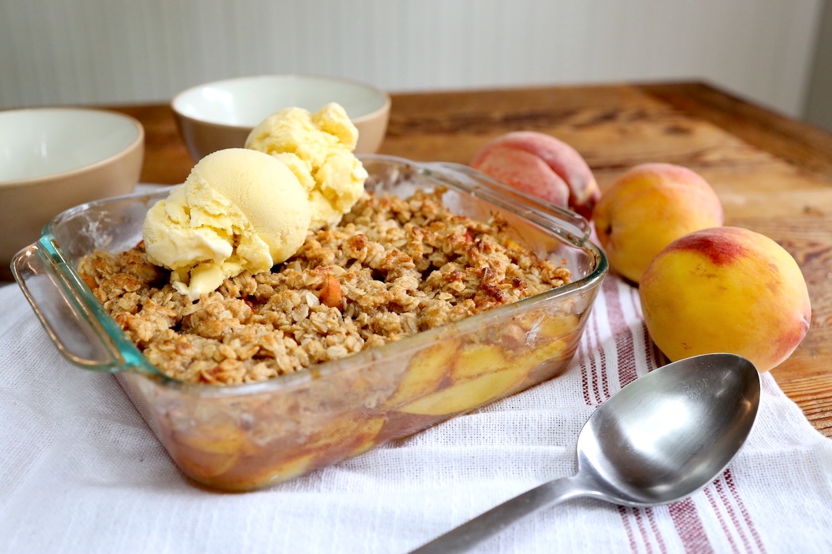 peach crumble with oats served with vanilla ice cream