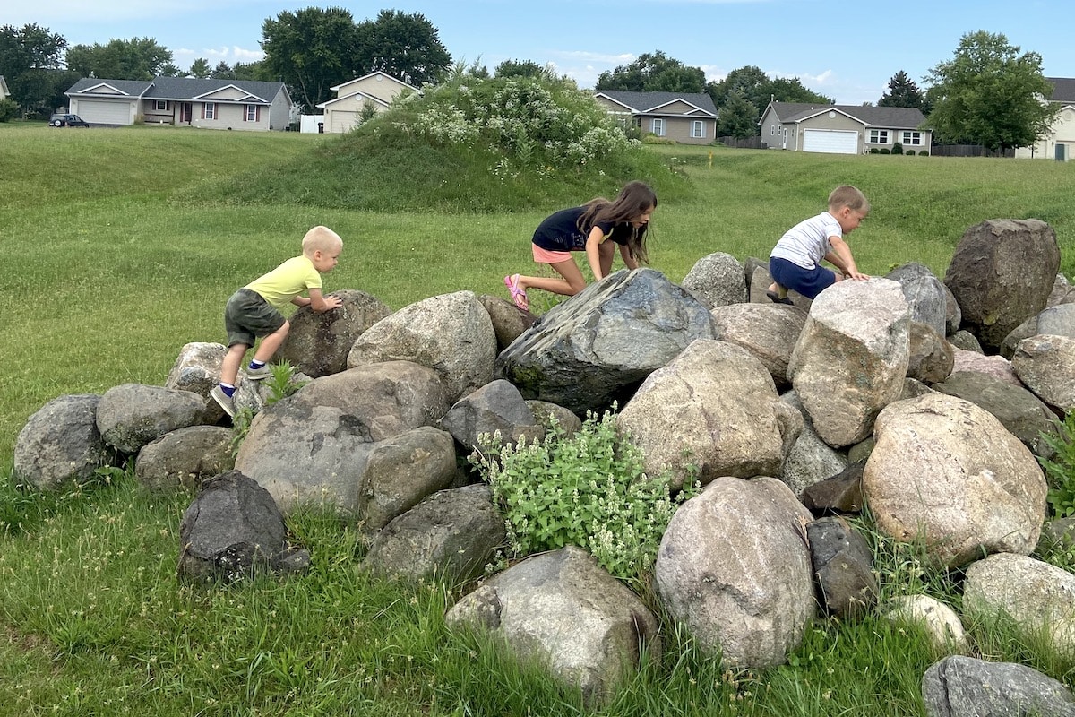 children playing on large rocks