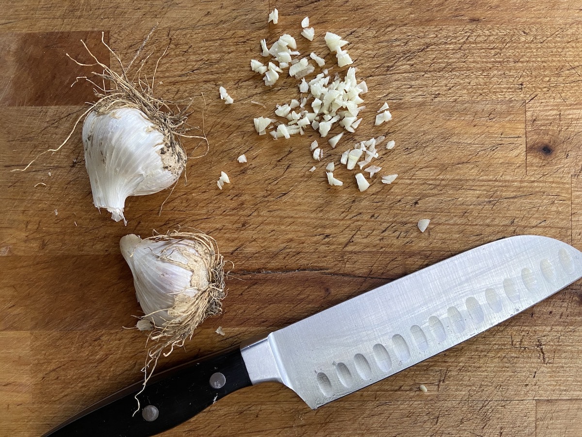 chopped storage garlic on cutting board