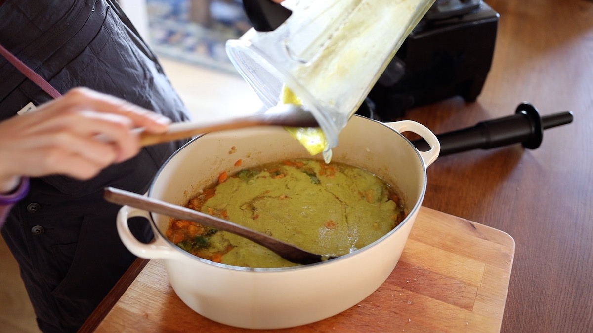 adding blended soup mixture back into pot