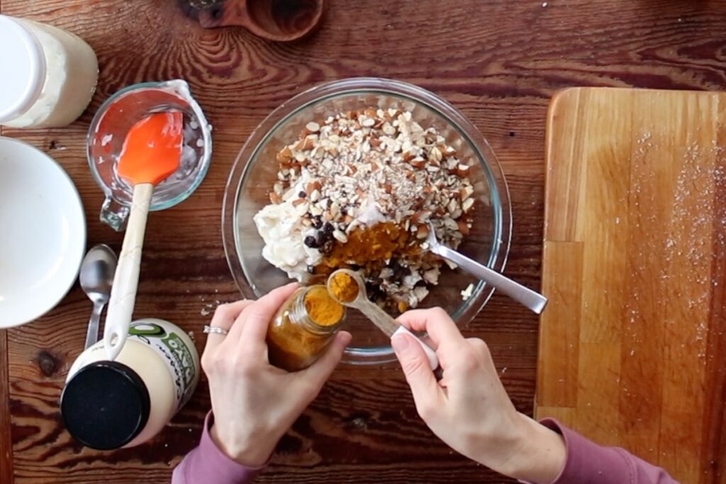 adding curry to chicken salad