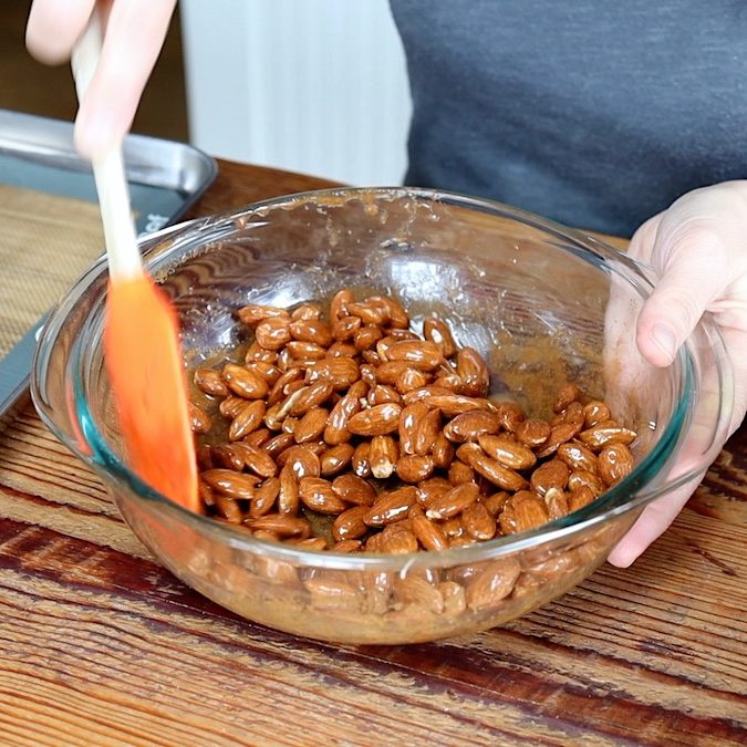 mixing almonds with cinnamon maple mixture