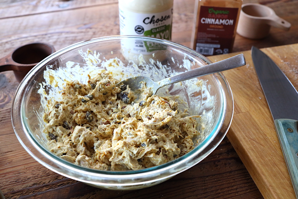 mixing curry chicken salad together