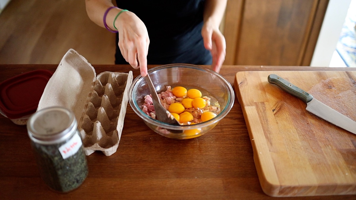 Adding eggs for egg muffin cups