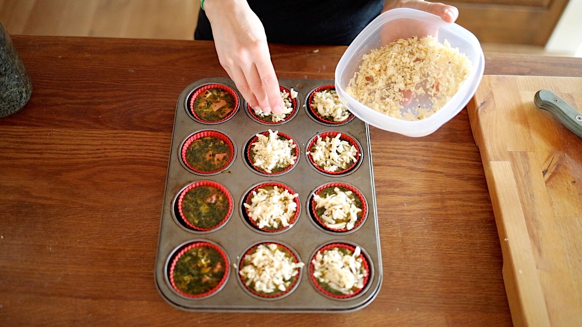 adding cheese on top of egg muffin cups