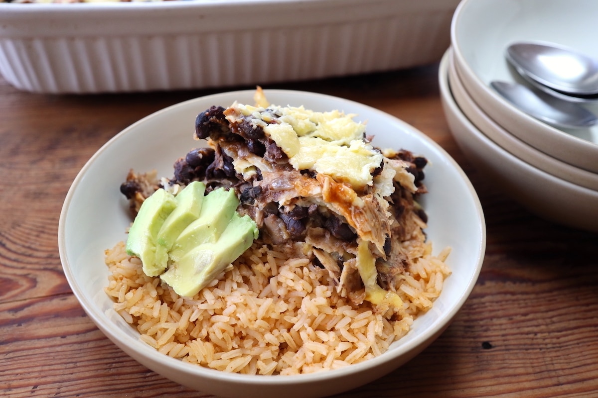 bowl of spanish rice and layered chicken enchilada casserole