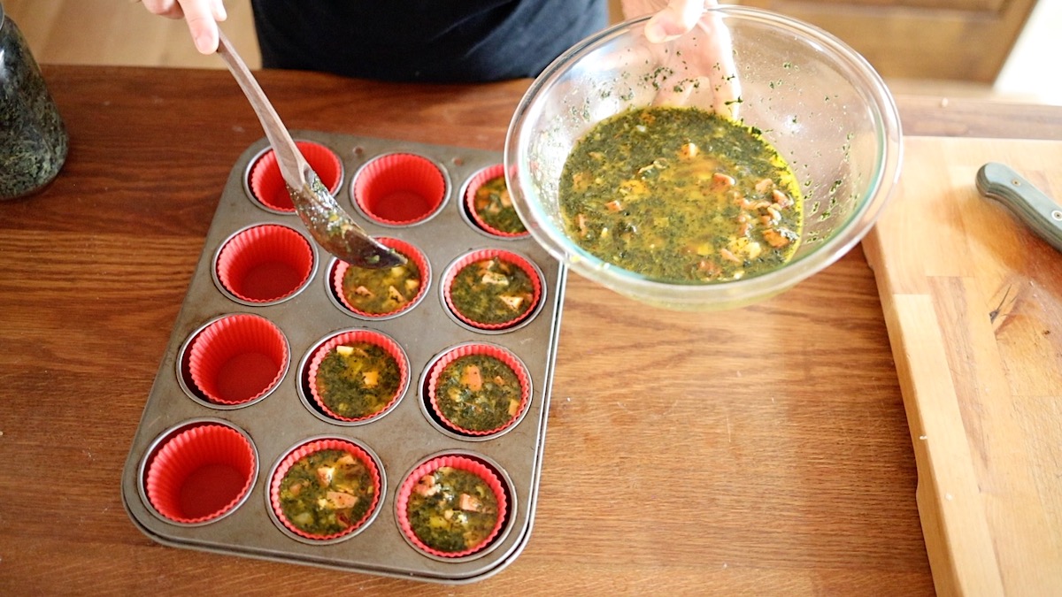 ladling egg mixture into muffin cups