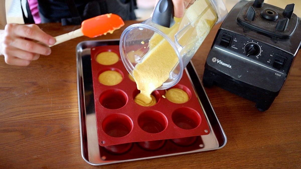pouring batter into muffin cups