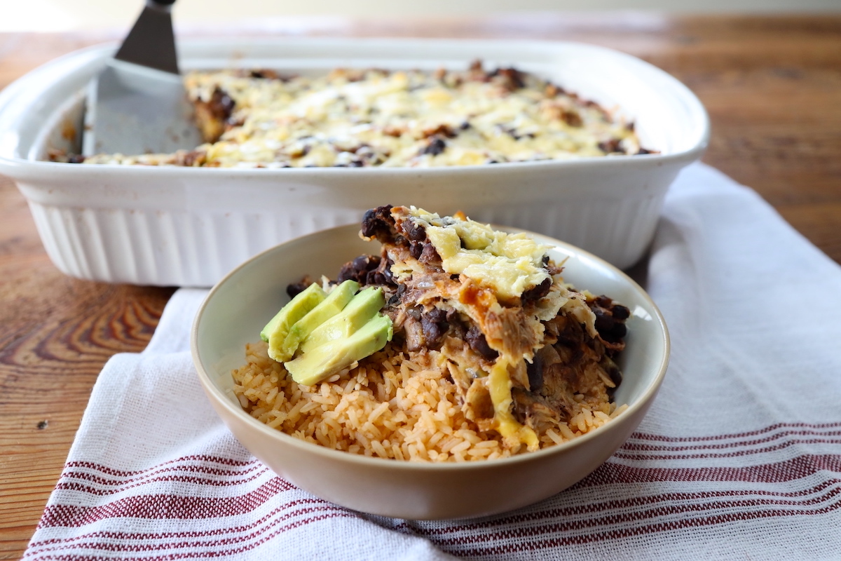 serving of layered chicken enchilada casserole with rice