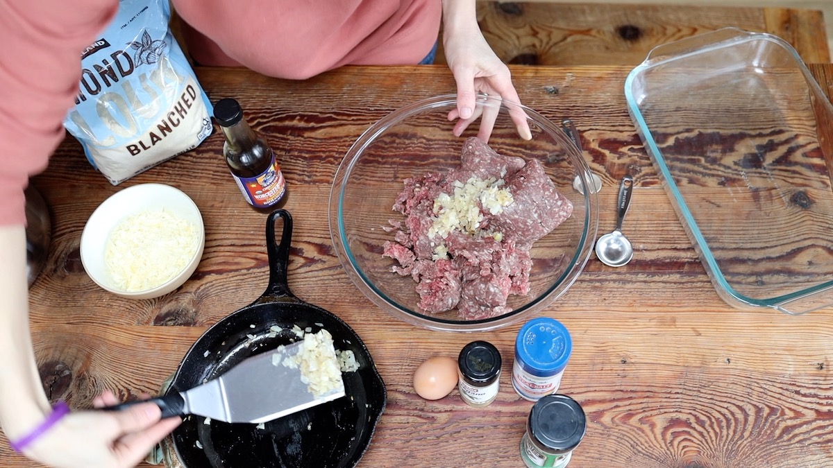 adding sauteed garlic and onions to ground beef