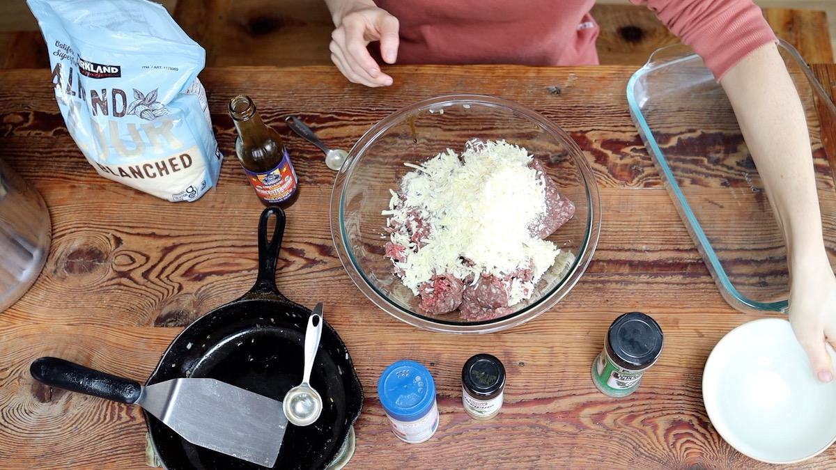 adding shredded cheese to meatloaf mix