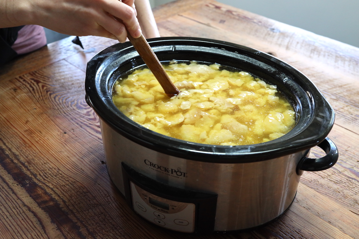 stirring rendered tallow in crock pot