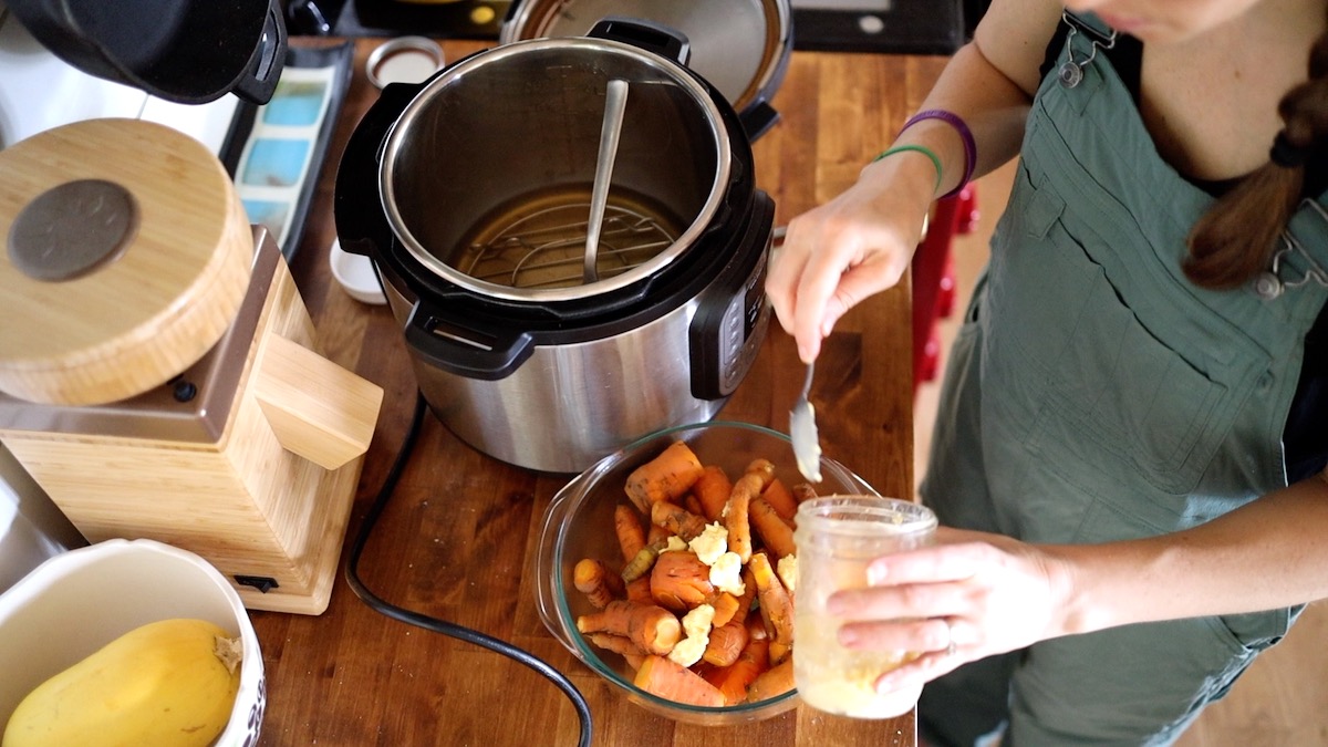 adding butter to carrots for carrot mash