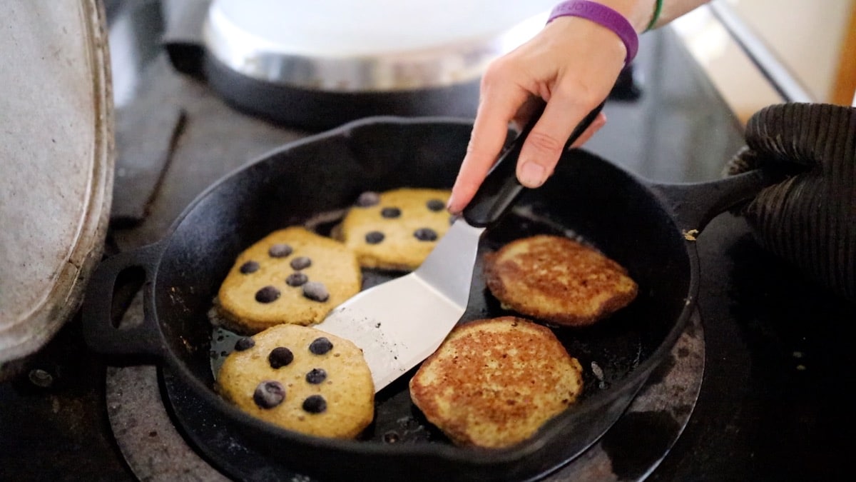 flipping pancakes in cast iron pan