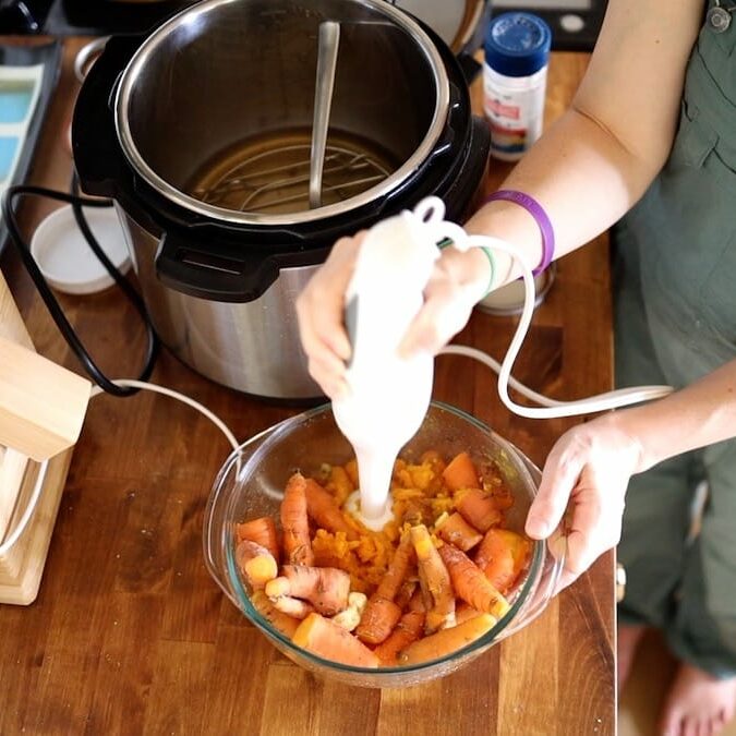 mixing carrots with immersion blender
