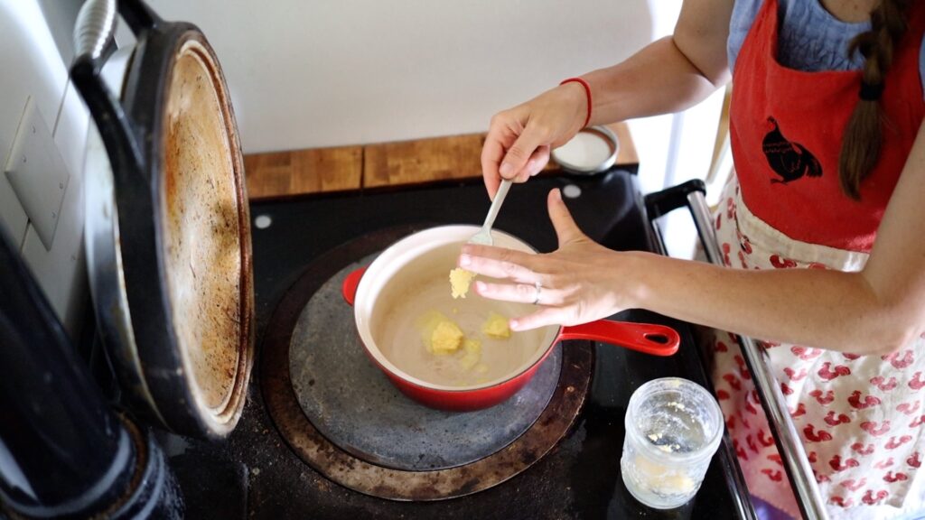 adding butter to pan for cream sauce