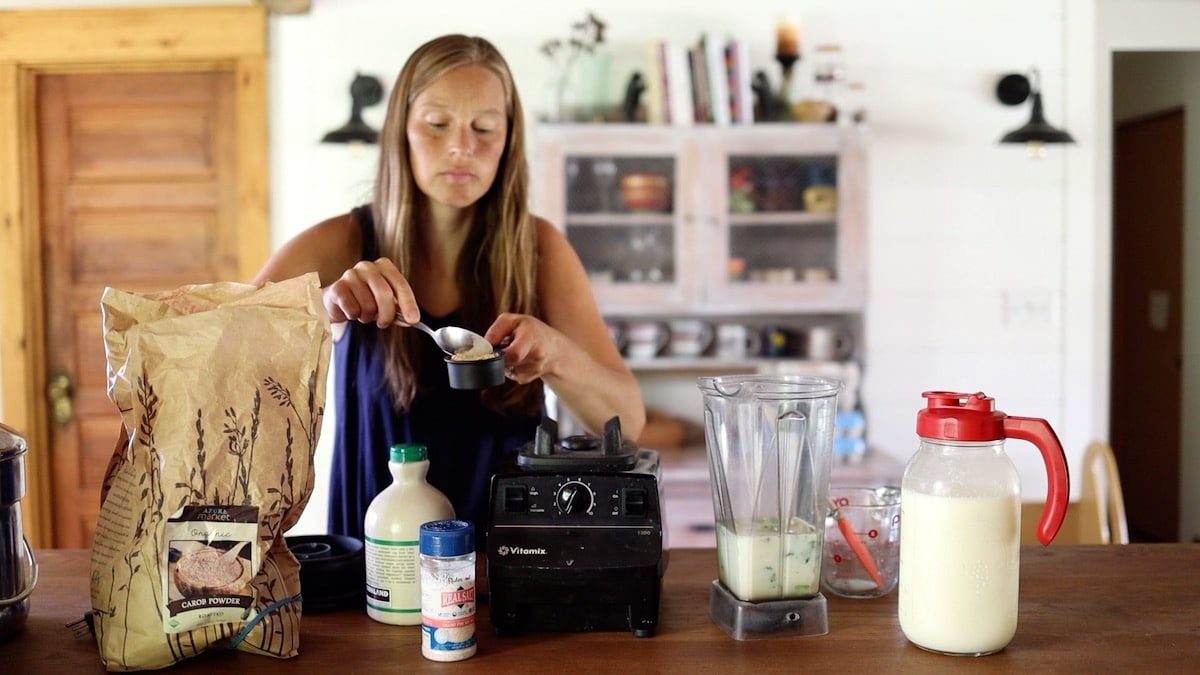 adding carob powder to blender