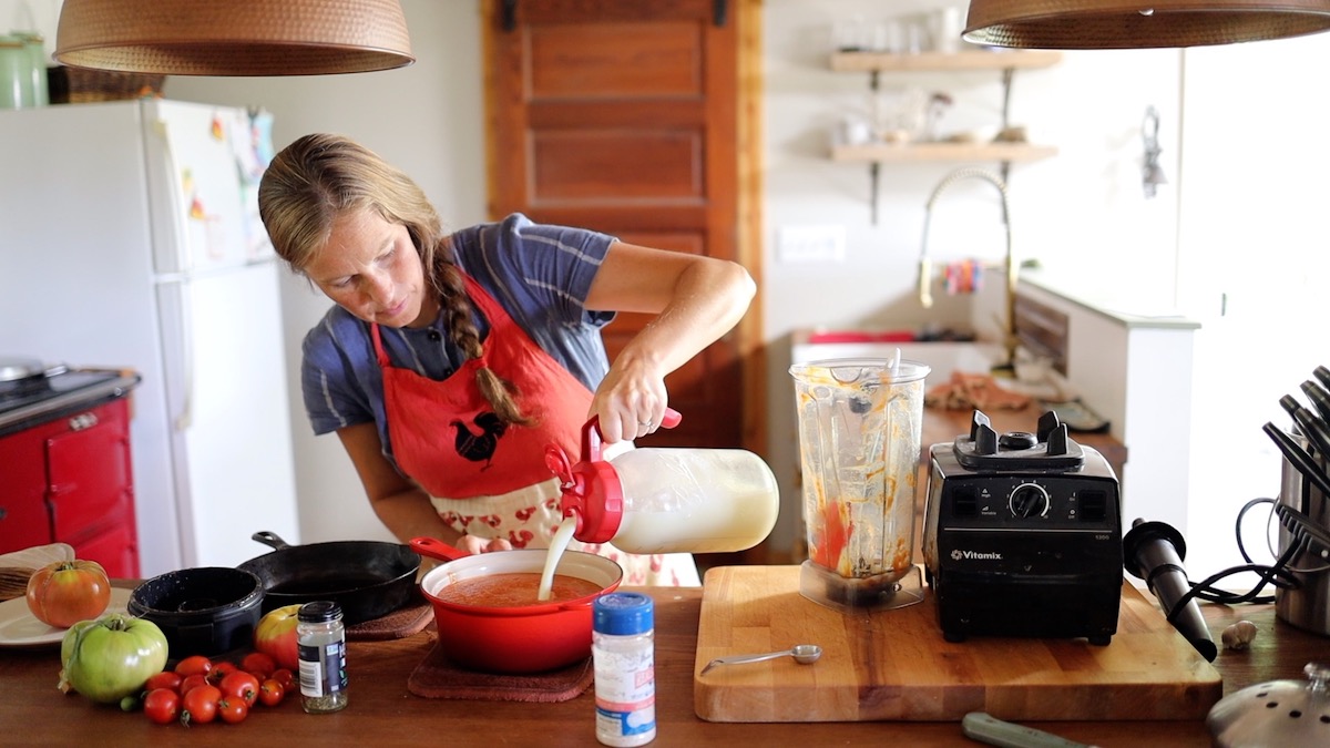 adding milk to tomato soup