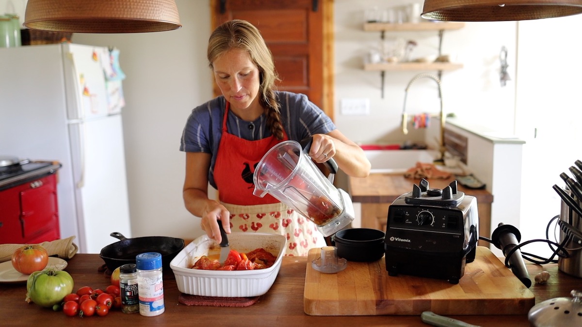 adding roasted tomatoes to blender