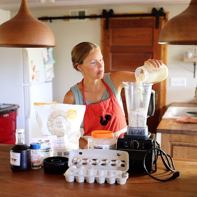 adding yogurt to blender for oat pancakes