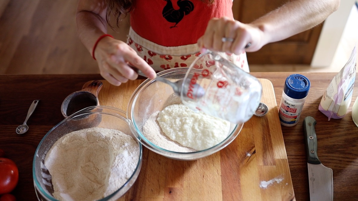 adding yogurt to pizza dough