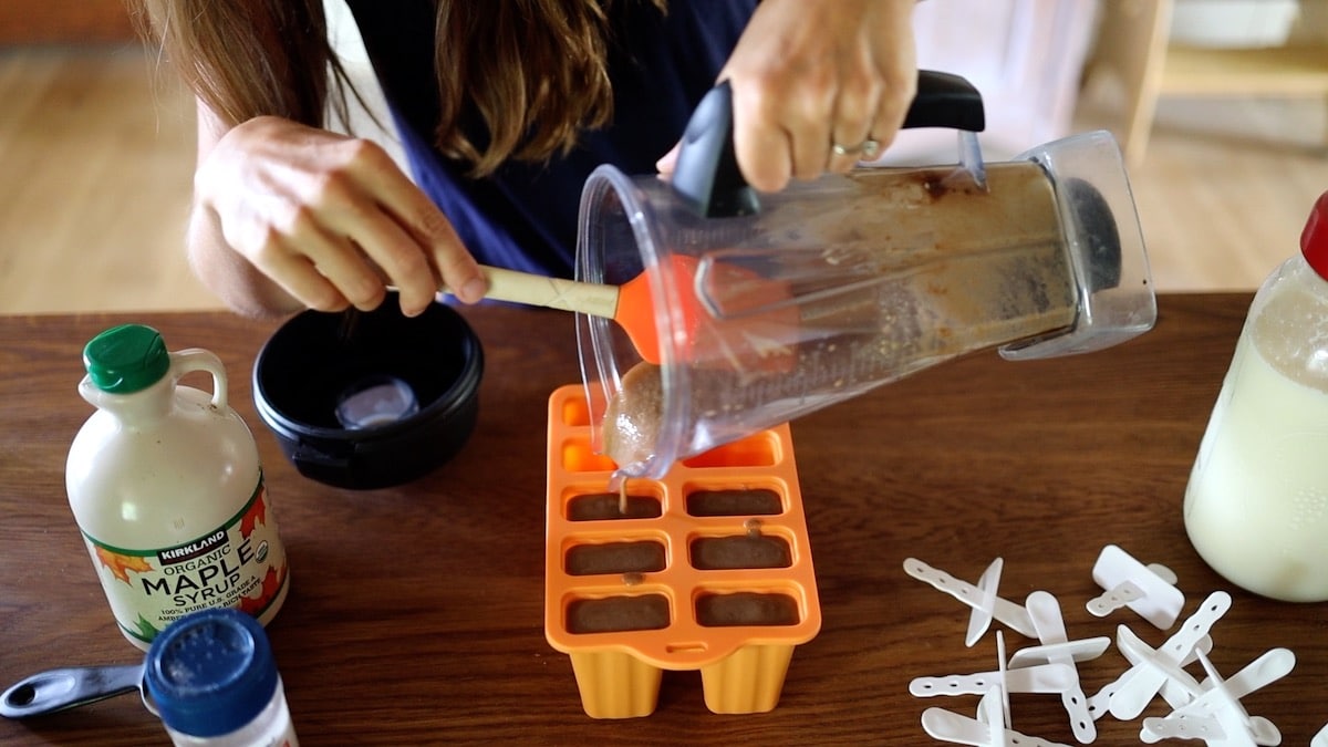 pouring into popsicle molds