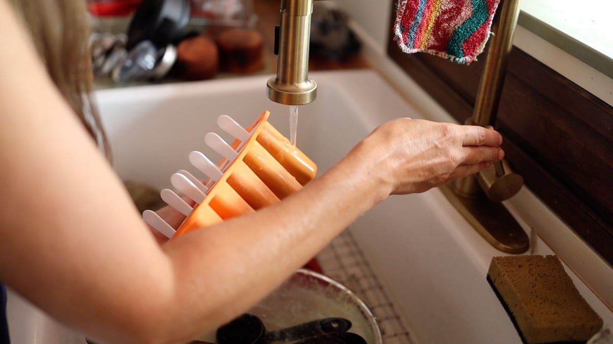 running warm water over popsicle mold