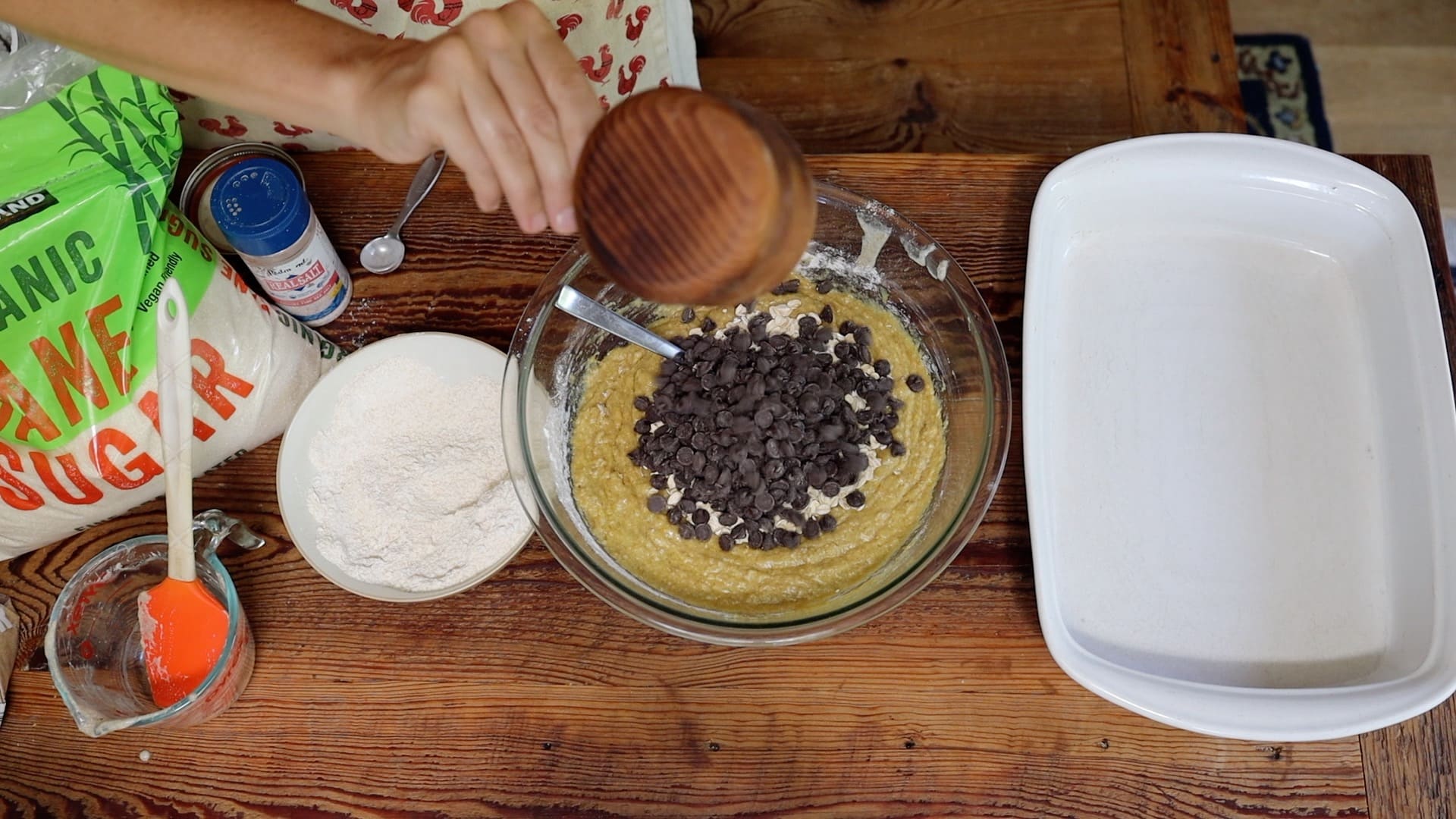 adding chocolate chips to cookie dough batter