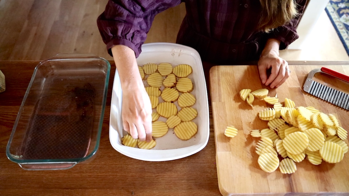 adding crinkle cut potatoes to pan