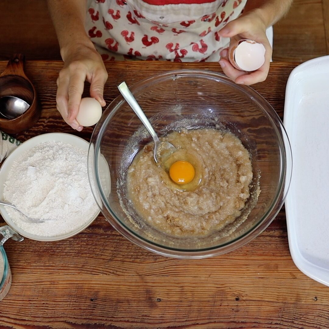 adding eggs to sourdough cookie bar batter