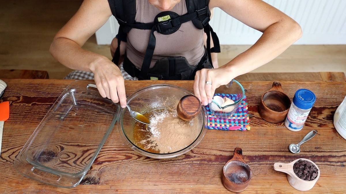 adding carob powder to brownie batter