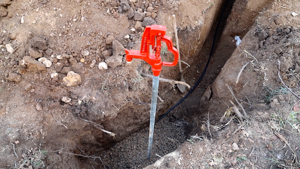 woodford yard hydrant install with stone around base