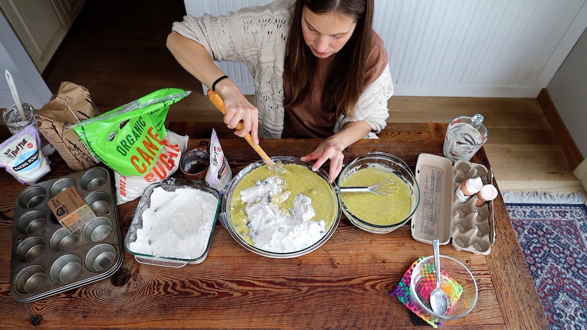 adding wet ingredients to dry ingredients for muffins