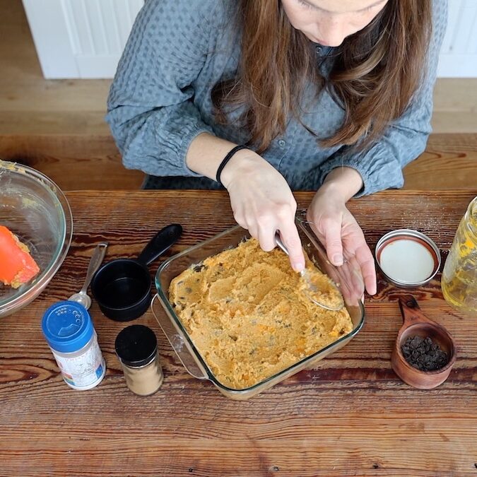 spreading batter for pumpkin blondies in baking dish