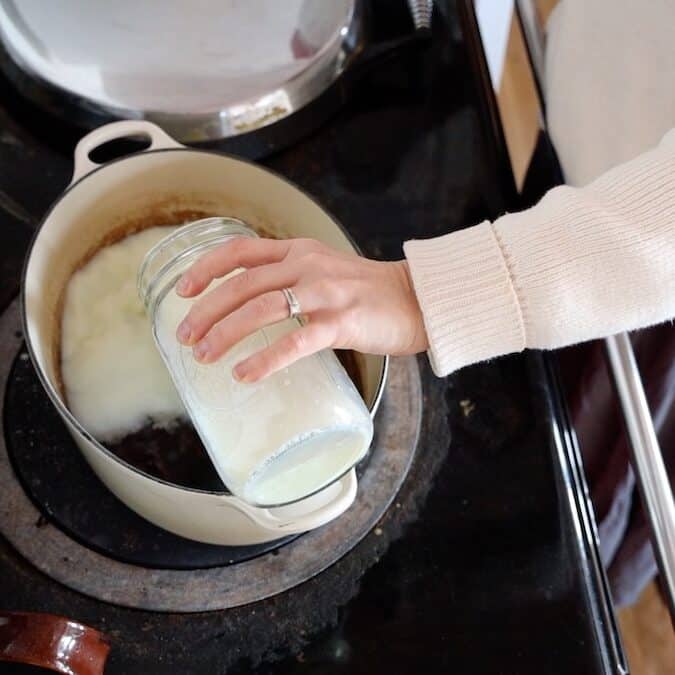 adding milk to pot for porridge