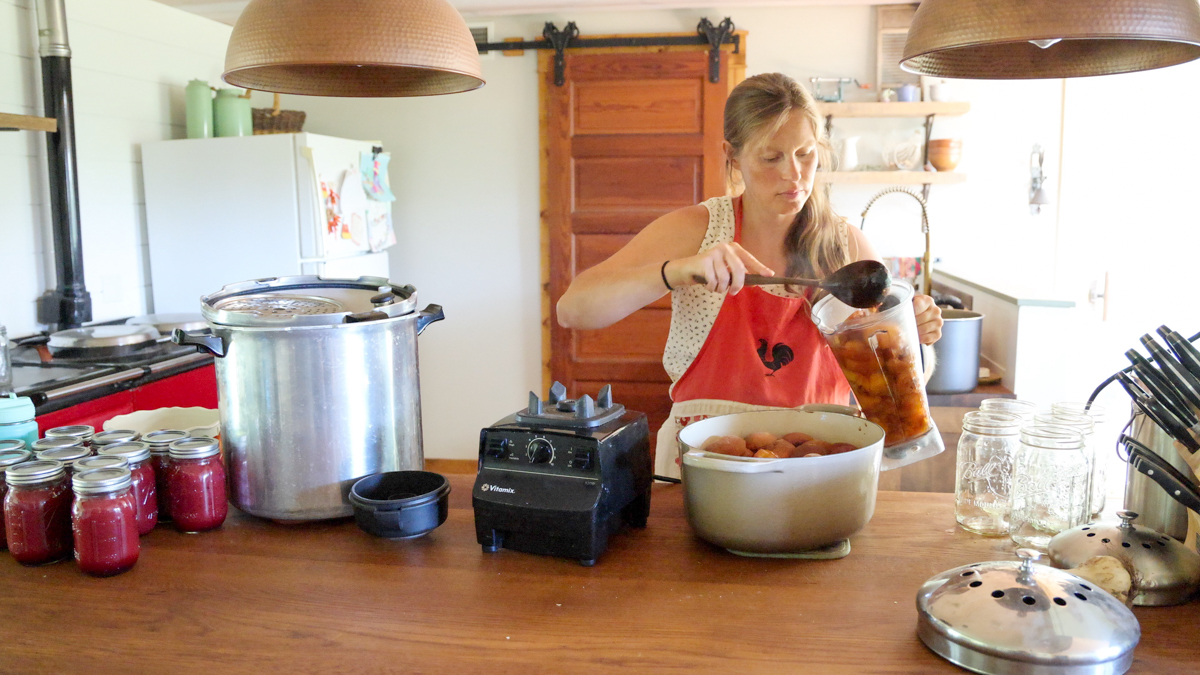 adding cooked peaches to blender