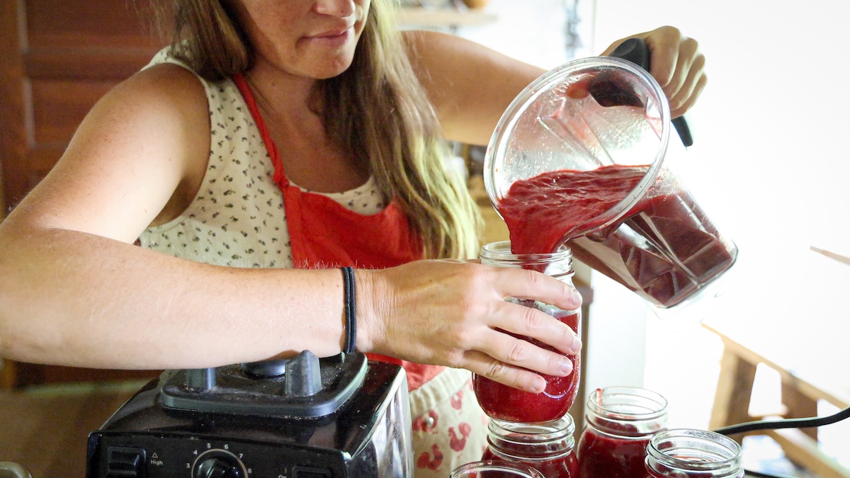 pouring plum sauce into jars