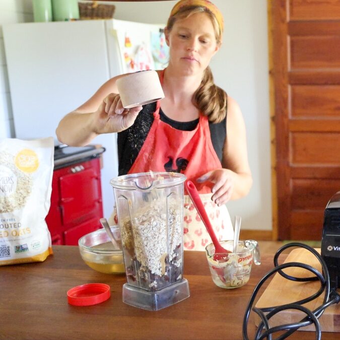 adding oats to blender for date eneregy balls