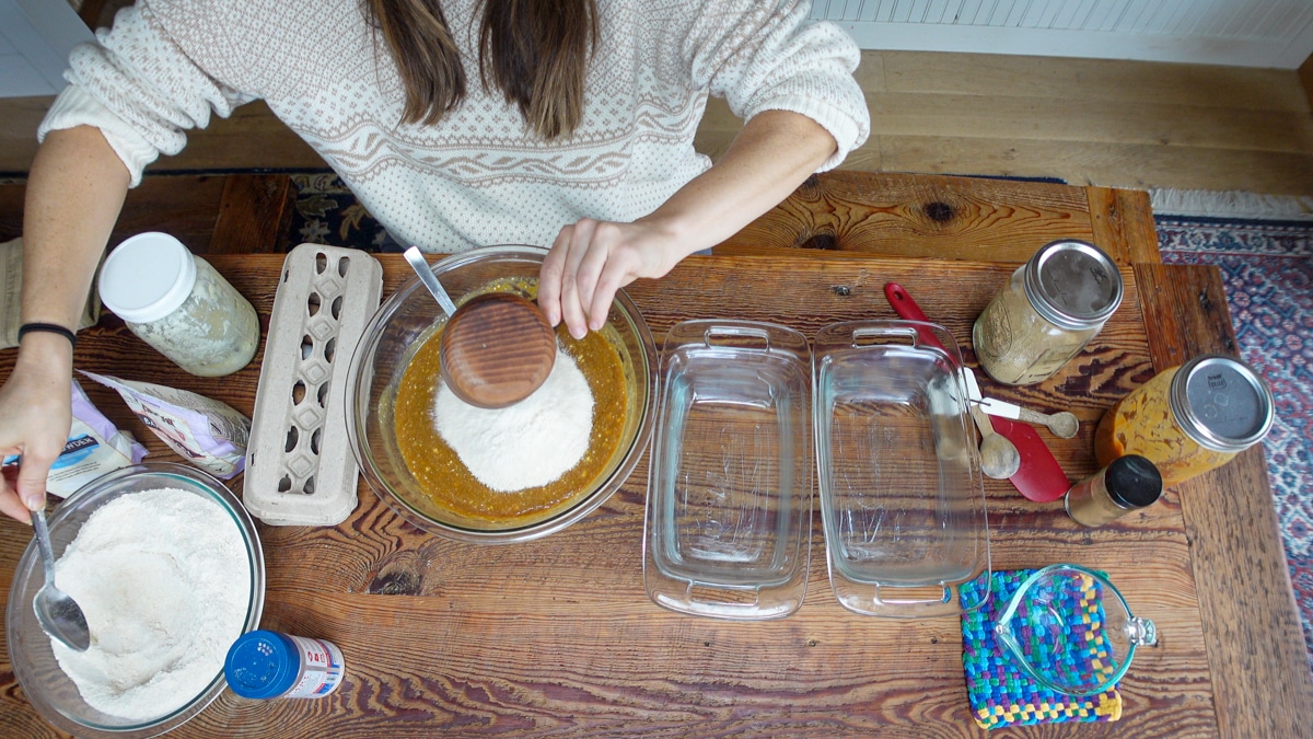 adding flour to applesauce bread