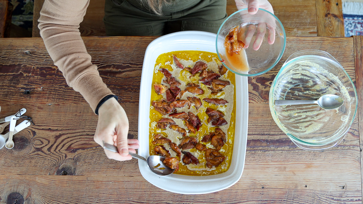spooning peaches in dish for easy peach cobbler