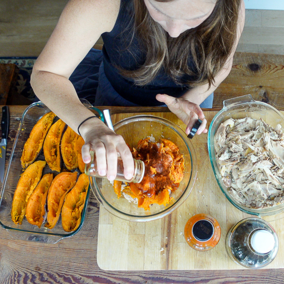 adding spices to chicken stuffed sweet potatoes recipe