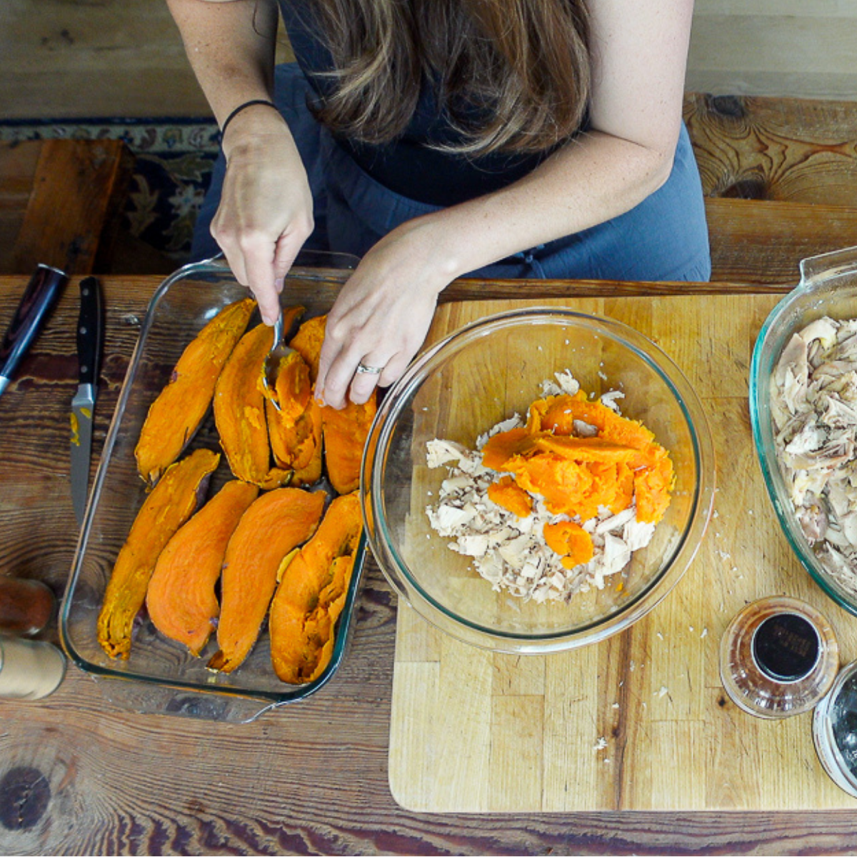 scooping out potatoes for chicken stuffed sweet potatoes