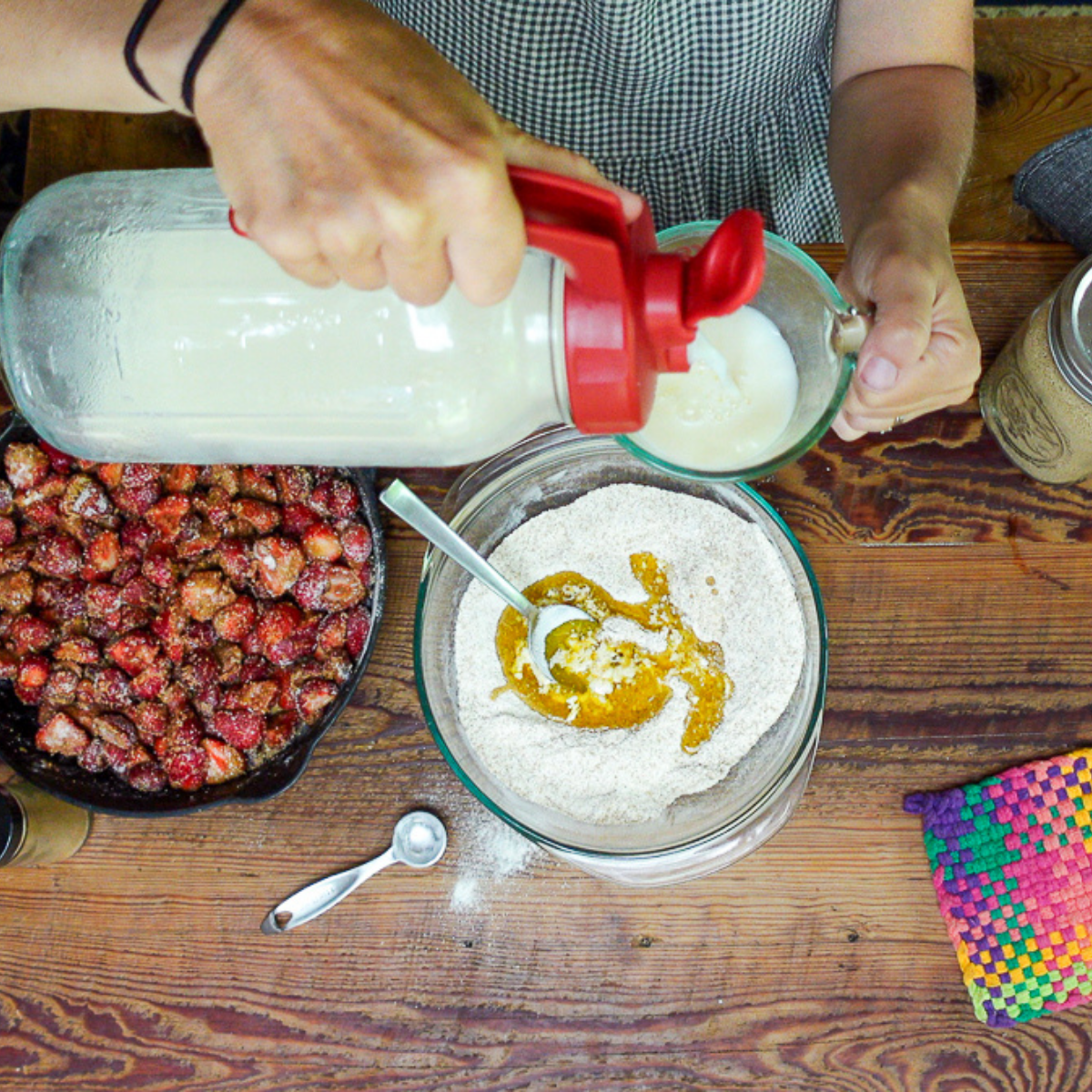 adding butter and milk for quick strawberry cobbler